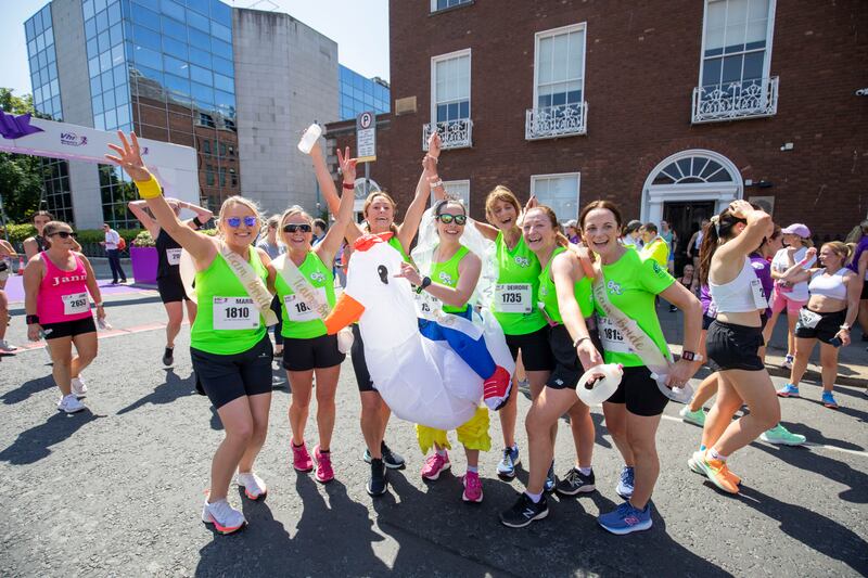 Marie Murphy, Paula Kealey, Thelma Bell, Maeve McKavanath (The Hen), Deirdre Fitzpatrick, Sarah Sharkey, and Catriona Murray, who are all from Belfast pictured at the finish line of the Vhi Women's Mini Marathon in Dublin. Photograph: Tom Honan/The Irish Times.