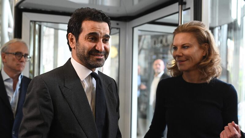 Newcastle United’s new director Amanda Staveley and husband Mehrdad Ghodoussi talk to the media as she leaves the foyer of St James’ Park in Newcastle on Friday.  Oli Scarff/AFP via Getty Images