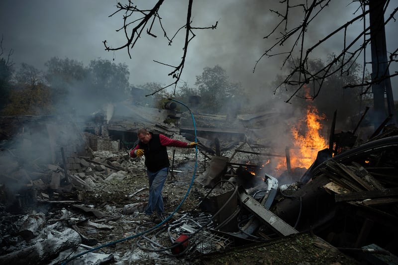 A man makes his way past burning wreckage following a Russian drone attack, which injured several people in the Donetsk region of eastern Ukraine. Photograph: Tyler Hicks/The New York Times
