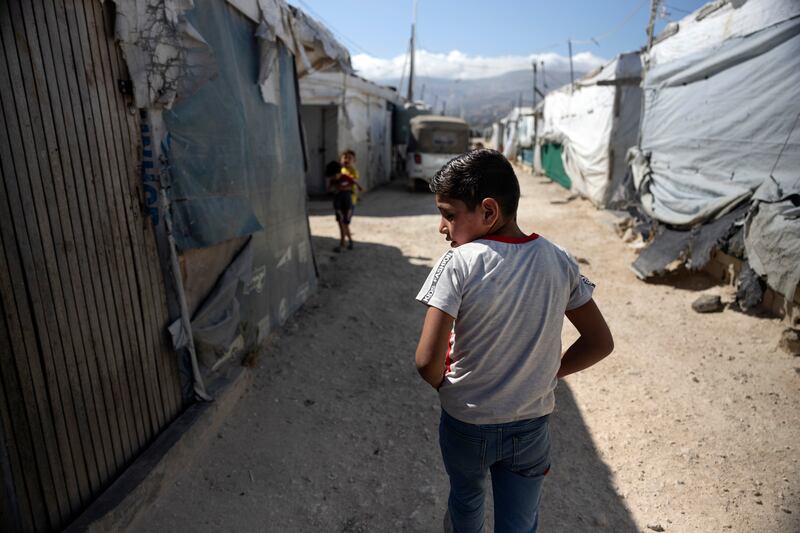 Yehia Ak Hamdo (9) proceeds to the classroom at the Makani centre in an informal tented settlement located in Saadnayel, within Lebanon’s Bekaa valley. Following his return to the family's Syrian farm in 2009, his father was killed, resulting in his mother and siblings facing difficulties to survive. Photograph: Chris Maddaloni/The Irish Times