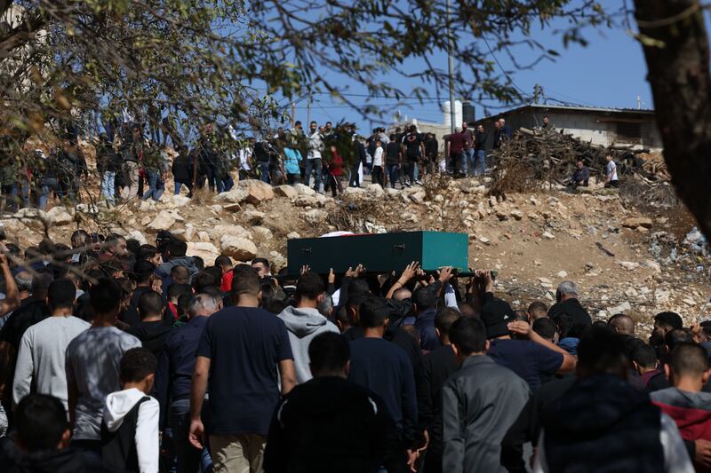 Palestinian mourners carry the body of Jehad Ajaj (26) during his funeral in the West Bank town of Deir Jarir, near Ramallah on October 9th. According to the Palestinian Health Ministry, Israeli settlers killed one Palestinian and injured three others in Deir Jarir village on the evening of October 8th. Photograph: Alaa Badarneh/EPA