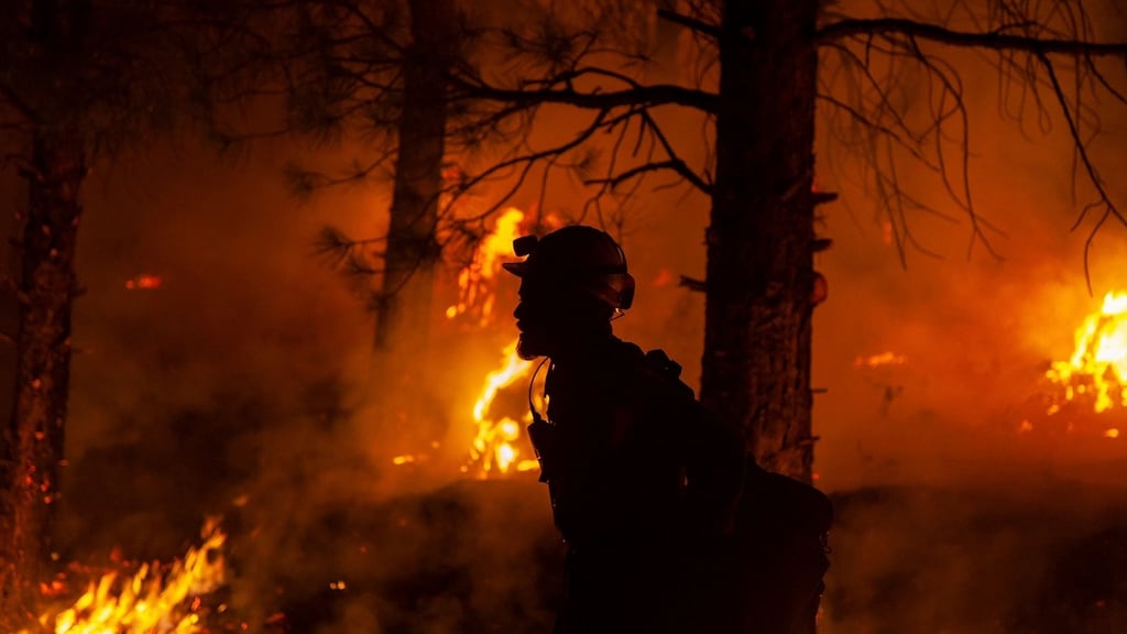 A firefighter during nighttime firefighting operations at the Bootleg Fire, near Klamath Falls, Oregon. Photograph: US Forest Service/AFP via Getty Images