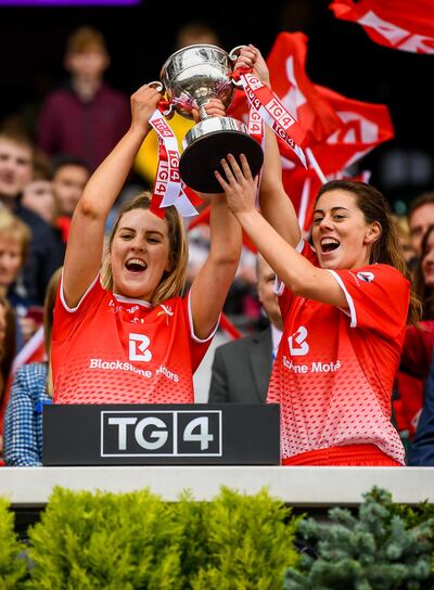 Louth's Aoife Halligan and Gráinne Murray lift the West County Hotel Cup following their victory in the TG4 All-Ireland Ladies Football Junior Championship final against Fermanagh at Croke Park, Dublin. Photograph: Stephen McCarthy/Sportsfile 