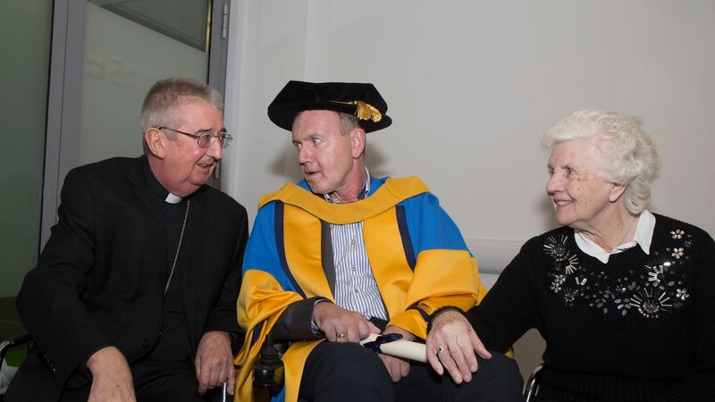Fr Tony Coote was conferred with an honorary doctorate of science by UCD. He is pictured here with Archbishop of Dublin Dr Diarmuid Martin and his mother Patricia. Photograph: Colm Mahady/Fennells