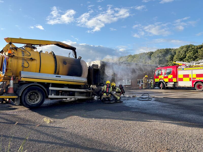 Emergency services attending to a vehicle on fire at a Department of Infrastructure depot near the Sandyknowes roundabout outside Belfast. Photo: PA/PA Wire 