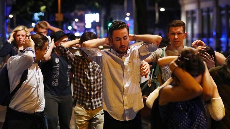 People leave the area with their hands up after the incident near London Bridge Photograph: Neil Hall/Reuters