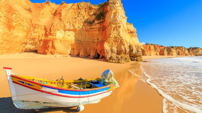 Head to  Praia da Rocha in Portimao, Portugal for some winter sun