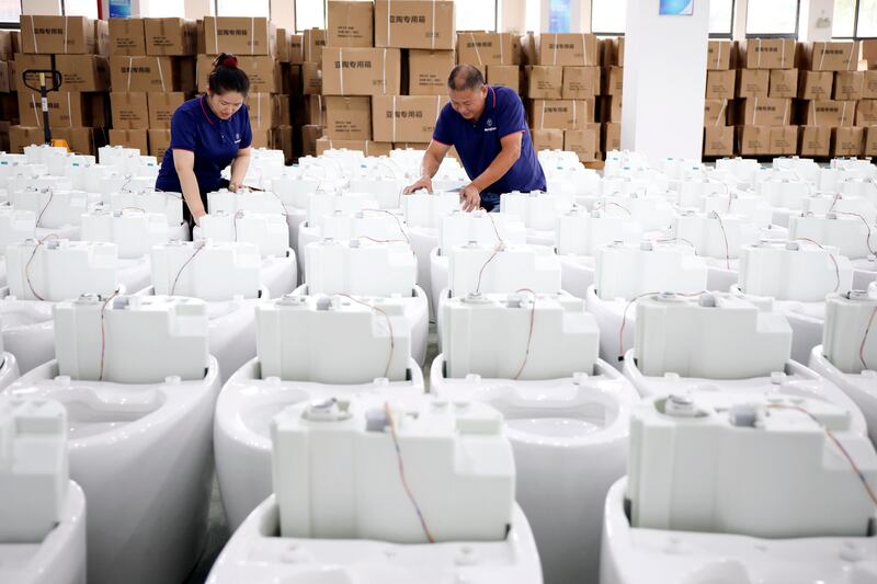 Smart toilets being assembled at a factory in Hangzhou, east China. Photograph: Xu Junyong//VCG/Getty Images