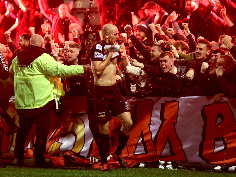 Bohemians' Georgie Kelly celebrates scoring goal with fans. Photograph: Bryan Keane/Inpho