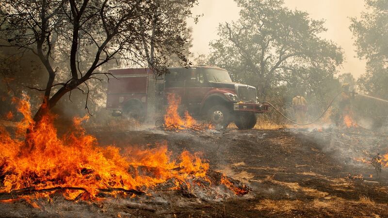 Firefighters douse a hotspot near various homes as the Carr fire continues to burn near Redding, California. Photograph: Josh Edelson/AFP/Getty Images.