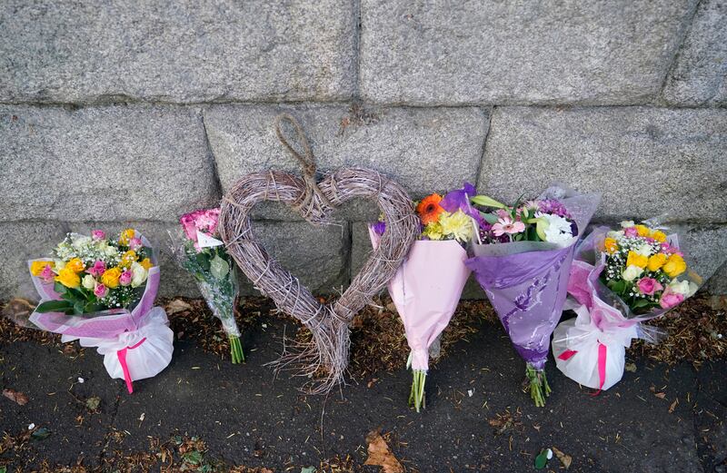 Flowers left outside St Michael's College in Dublin on Monday after the deaths of two recent graduates, Andrew O'Donnell and Max Wall, on the Greek island of Ios. Photograph: Niall Carson/PA Wire