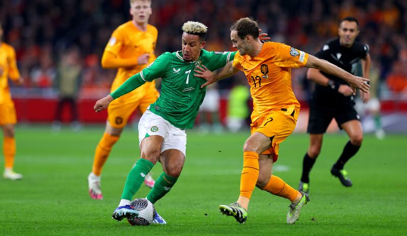 Ireland’s Callum Robinson is challenged by Daley Blind of the Netherlands. Photograph: Ryan Byrne/Inpho 