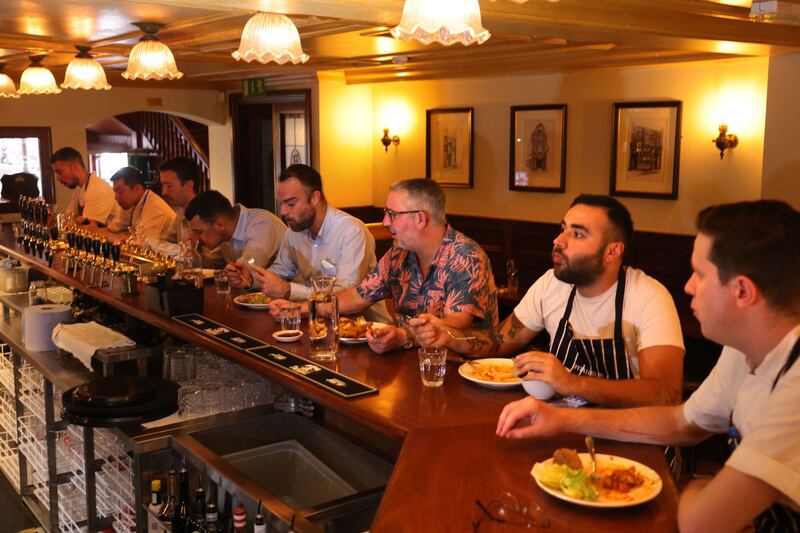 Spitalfields: staff sit down for dinner before they open to the public. Photograph: Dara MacDónaill