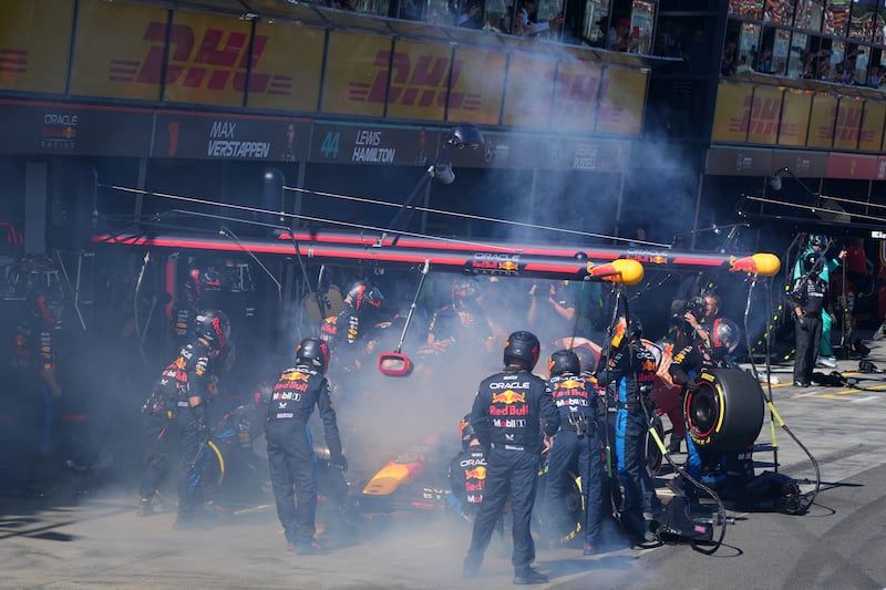 Red Bull mechanics deal with smoke coming out of Max Verstappen's car as he was forced out of the Australian Grand Prix. Photograph: Scott Barbour/AFP via Getty Images