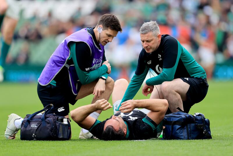 Ireland's Physiotherapist Keith Fox treats James Lowe for a back spasm during the warm-up. The Leinster wing misses out replaces Calvin Nash. Photo: Dan Sheridan/Inpho