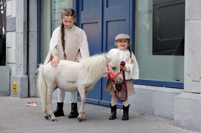 Mary Bridget Joyce (9) and Stephanie Joyce (4) with their new filly foal at Ballinasloe Horse Fair. Photograph: Alan Betson