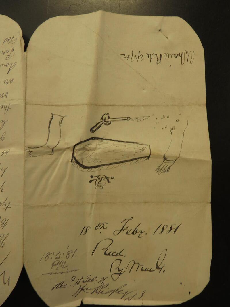 A rare example in a threatening letter of two severed limbs, an equally rare three-dimensional coffin, an antiquated flintlock being discharged and an unusual skull and cross bones.  (Courtesy of the National Archives of Ireland: CSO Letter book, 15, February 1881)
