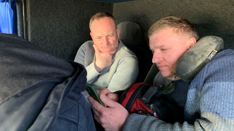 Construction worker Petro Hirnyy and welder Petro Antonyuk en route  from Paris to Lviv to join the Ukrainian territorials against the Russians. They keep a close watch on their smartphones.  Photograph: Lara Marlowe