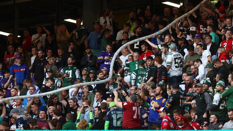 Fans create a beer snake with empty plastic glasses during the game at Tottenham Hotspur Stadium. Photograph:  Clive Rose/Getty Images