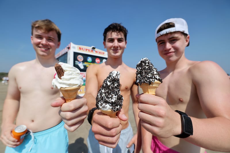 Alex Bulmer, Hugo Lynch and Ross O’Brien 
from Malahide enjoying Portmarnock beach during high temperatures at the start of a run of sun filled days this week. Photo: Alan Betson / The Irish Times