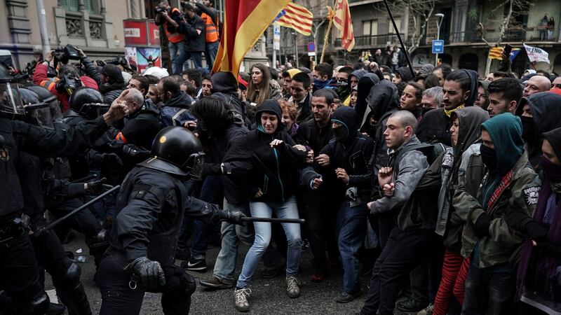 Catalan Mossos d’Esquadra regional police officers clash with pro-independence supporters trying to reach the Spanish government office in Barcelona on Sunday. Photograph: Felipe Dana/AP