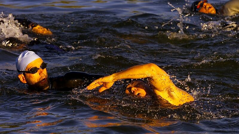 Blind athlete David Bigoney gets some directional help from his guide in the water   at the ITU World Triathlon Championships in Edmonton, Alberta, Canada. Photograph: Brian Bahr/Allsport
