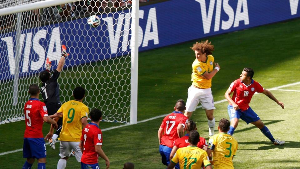 Brazil’s David Luiz scores the opener against Chile at the Mineirao Stadium in Belo Horizonte. Photograph: Leonhard Foeger / Reuters