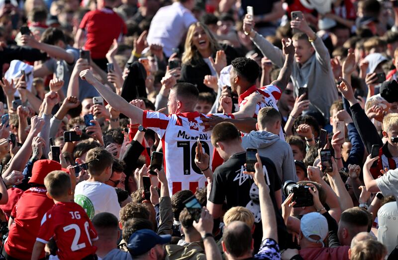 Lincoln City's Jack Moylan (left) and Reeco Hackett celebrate with fans after the League One win over Wycombe Wanderers last month. Photograph: Bruce Rollinson/PA