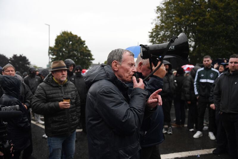 Breandán Mac Cionnaith speaks through a loudspeaker at the front line of the protest telling residents and supporters to stay on the streets. Photograph: Charles McQuillan/Getty Images