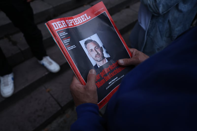 A Ulrich Siegmund supporter waits for the politician to sign copies of Der Spiegel that show him on the cover with the headline: "The most dangerous man in Germany". Photograph: Sean Gallup/Getty