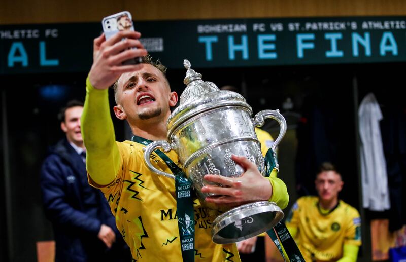 St Patrick's Athletic's Sam Curtis celebrates with the FAI Cup after victory over Bohemians at the Aviva Stadium, Dublin. Photograph: Ryan Byrne/Inpho 