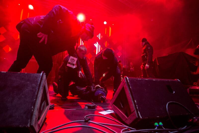 A man is held on the ground on stage by security personnel after he attacked the mayor Photograph: Piotr Hukalo/East News/AFP/Getty
