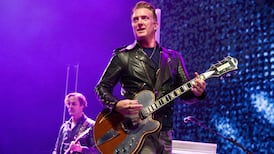 Josh Homme of Queens of the Stone Age kicks female photographer in head