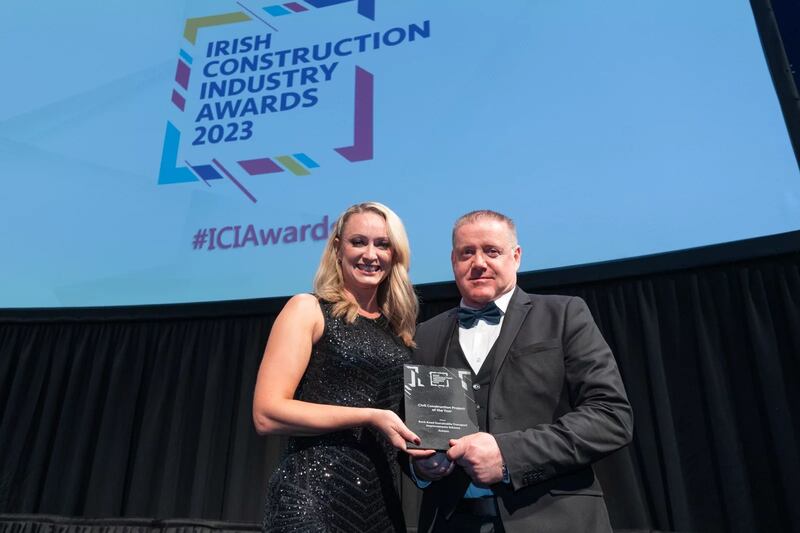 Amy Kruse, awards judge, presents the civil construction project of the year award to Ollie Raftery, Actavo