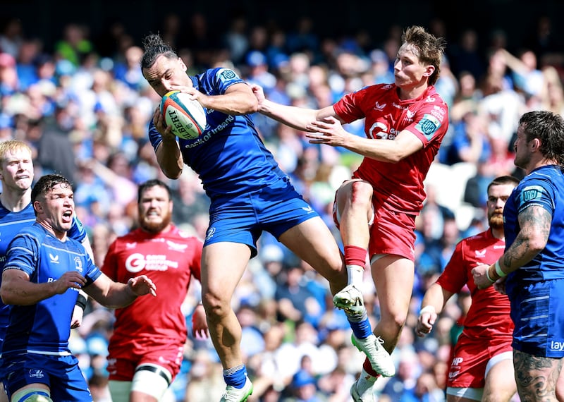 Leinster's James Lowe fields a high ball under pressure from Scarlets' Ellis Mee. Photograph: Dan Sheridan/Inpho