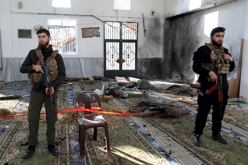 Armed security officers cordon an area following a deadly explosion near a mosque in a predominantly Alawite area of Syria's Homs. Photograph: Omar Haj Kadour/AFP via Getty Images