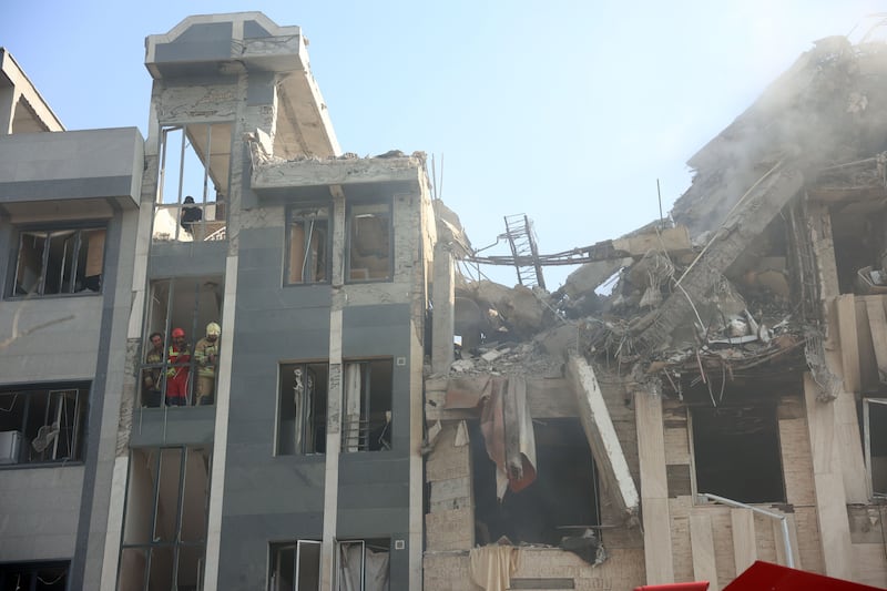 Firefighters work in building that was hit by Israeli air strikes in central Tehran. Photograph: EPA