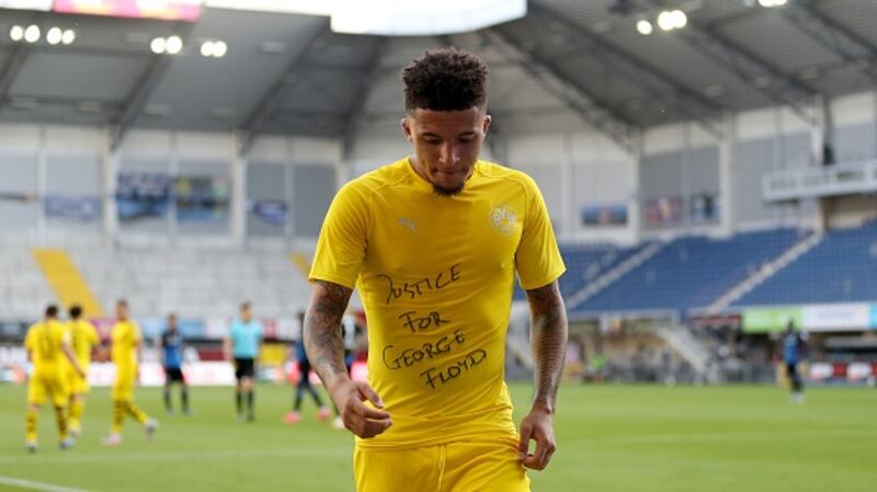 Jadon Sancho of Dortmund celebrates after scoring with a ‘Justice for George Floyd’ shirt. Photograph: Getty Images