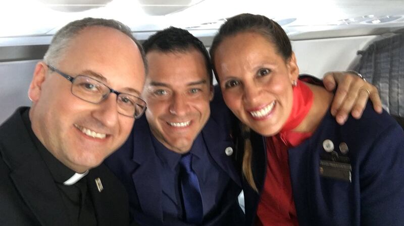 A member of Pope Francis’ entourage, Antonio Spadaro, with the happy couple. Photograph: Antonio Spadaro/Twitter