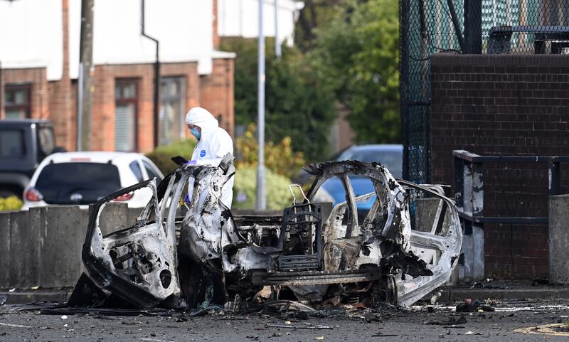 Forensic officers on Sunday examined the scene of a car bomb attack on Dunmurry police station in Co Antrim. Photograph: Charles McQuillan/Getty Images