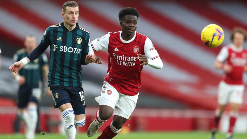 Bukayo Saka evades  Ezgjan Alioski  during Arsenal’s win over Leeds. Photograph: Catherine Ivill/EPA