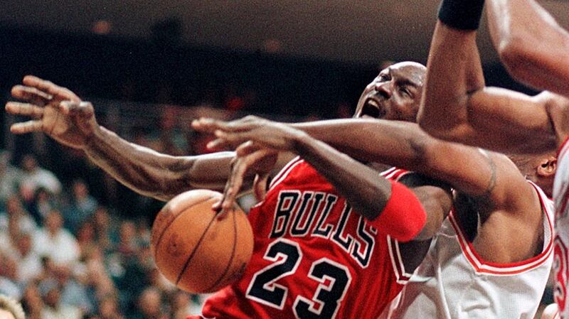 Michael Jordan of the Chicago Bulls gets fouled as he drives to the basket. The NBA in the 80s and 90s featured  reckless fouls, frequent brawls and a relentless physical confrontation between players. Photograph: Tony Ranze//AFP via Getty Images