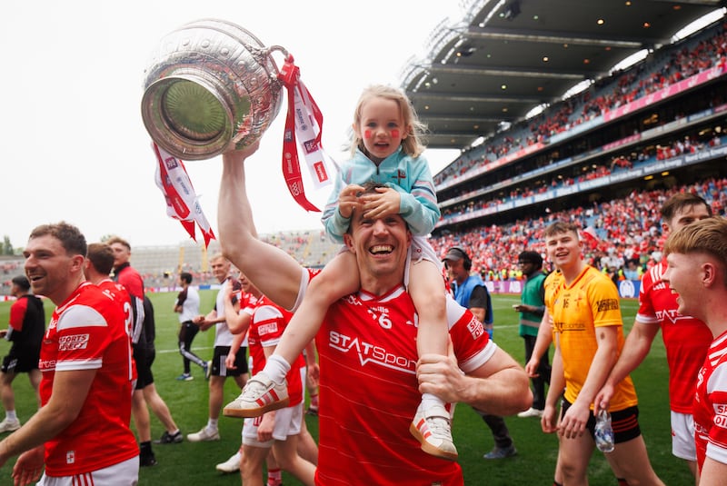 Louth's Bevan Duffy celebrates with his daughter Lydia after the game. Photograph: Tom Maher/Inpho