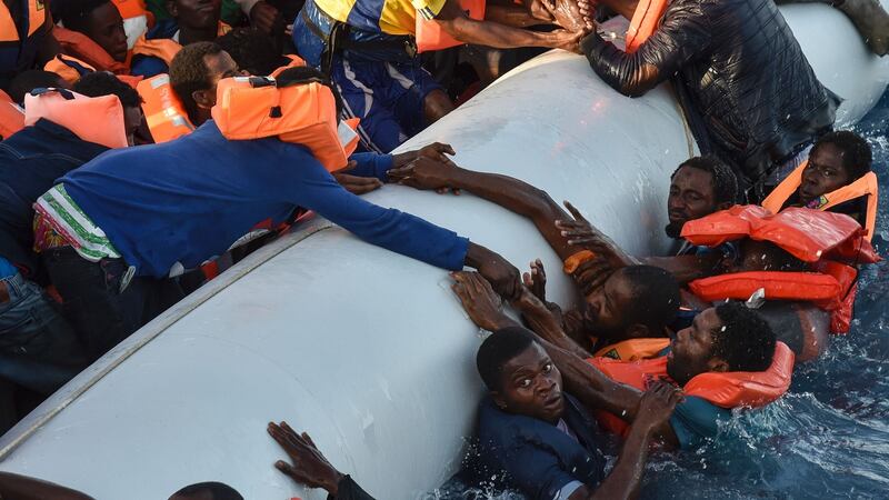Migrants and refugees fall in the water during a rescue operation run by the Italian Red Cross and Migrant Offshore Aid Station on Thursday. Photograph: Andreas Solaronadre/Getty Images/AFP