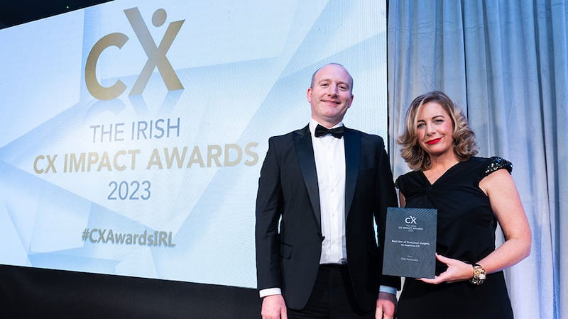 Charlotte Buckley, awards judge, presents the best use of customer insights to improve CX award to John Fitzgerald, ESB Networks.