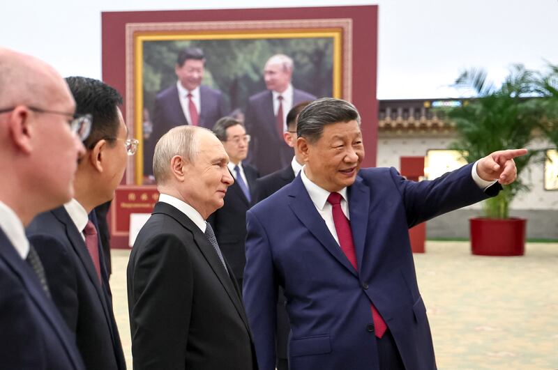 Vladimir Putin and Xi Jinping tour a photo exhibition on Russia-China ties in Beijing. Photograph: Alexander Kazakov/AFP/Getty Images