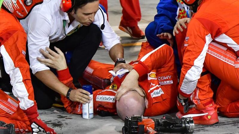 A pitman receives medical assistant after an incident with Kimi Raikkonen during the Bahrain Grand Prix. Photograph: Giuseppe Cacace/AFP