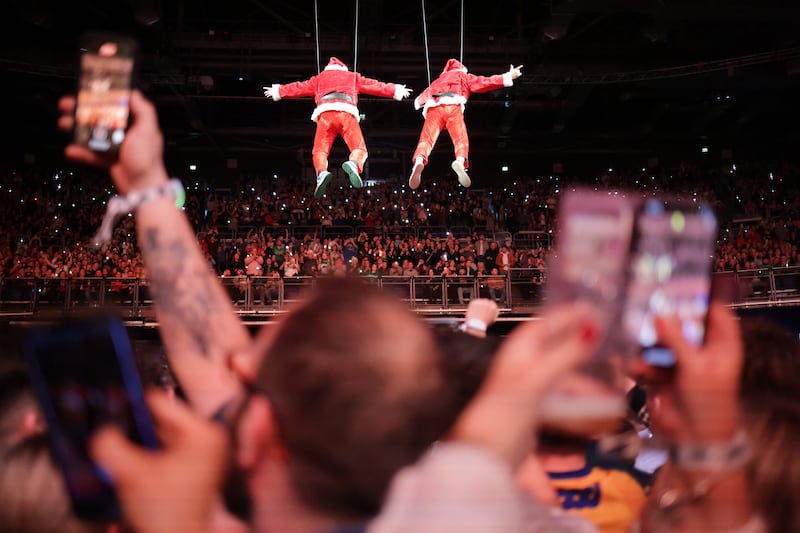 The 2 Johnnies arrive on aerials to deliver their podcast to a large audience at the 3Arena in Dublin, Ireland. Photograph: Chris Maddaloni/The Irish Times
