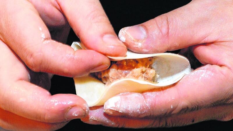 Kwanghi Chan demonstrating how to make a potsticker dumpling.  Photographs: Dara Mac Dónaill
