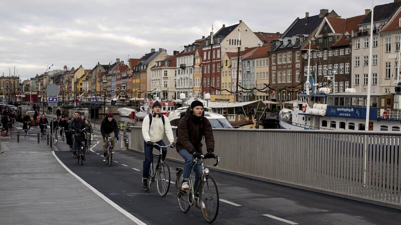 Commuters ride over the bridge connecting the inner part of Copenhagen with the neighborhood of ChristianshavnPhotograph: Betina Garcia/The New York Times